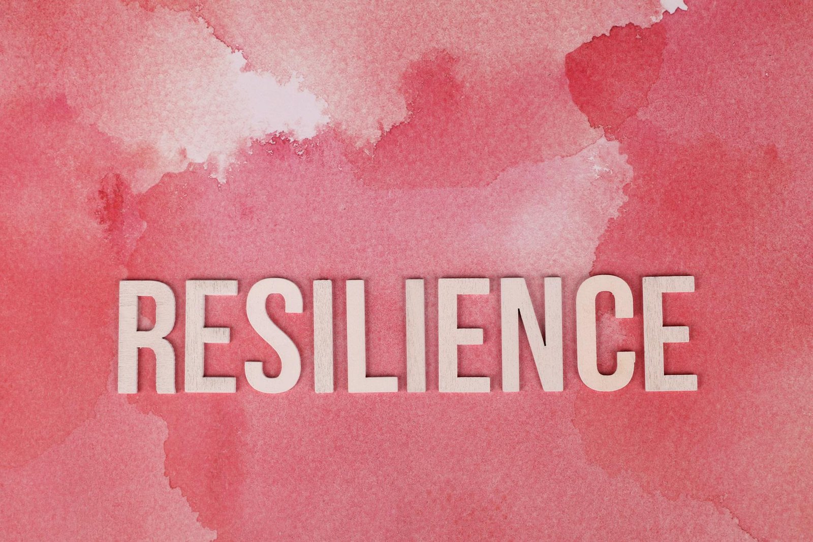 the word resilience on pink surface